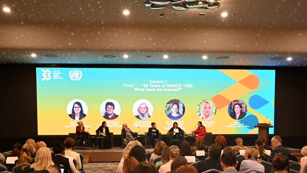 people sitting on a panel for the 25th anniversary of wps
