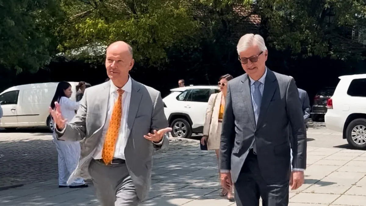 Two men in suits walking 