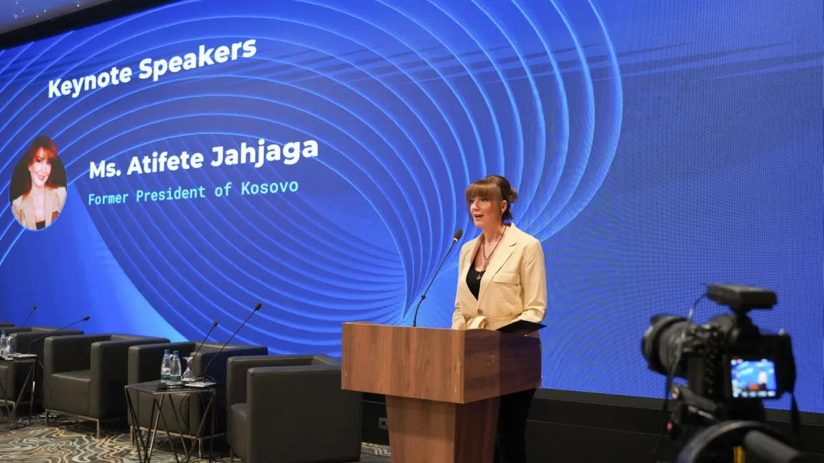 Woman speaking at a podium 