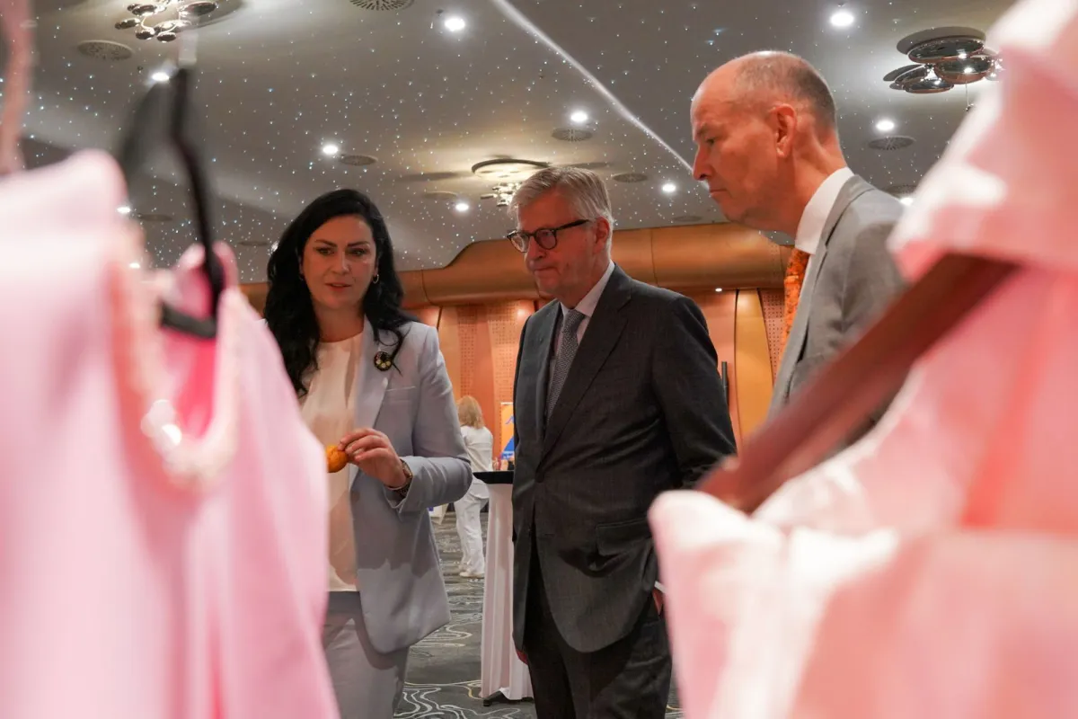 Two men and one woman looking at some products 