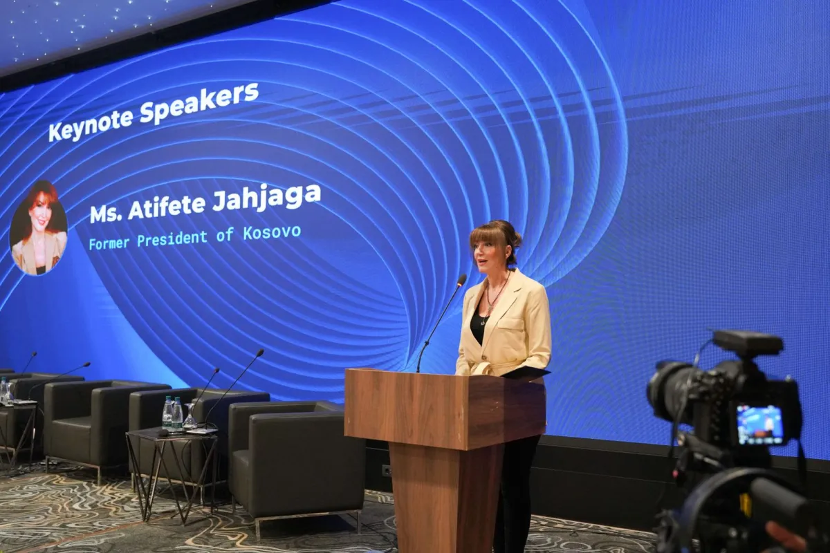 Woman speaking at a podium 