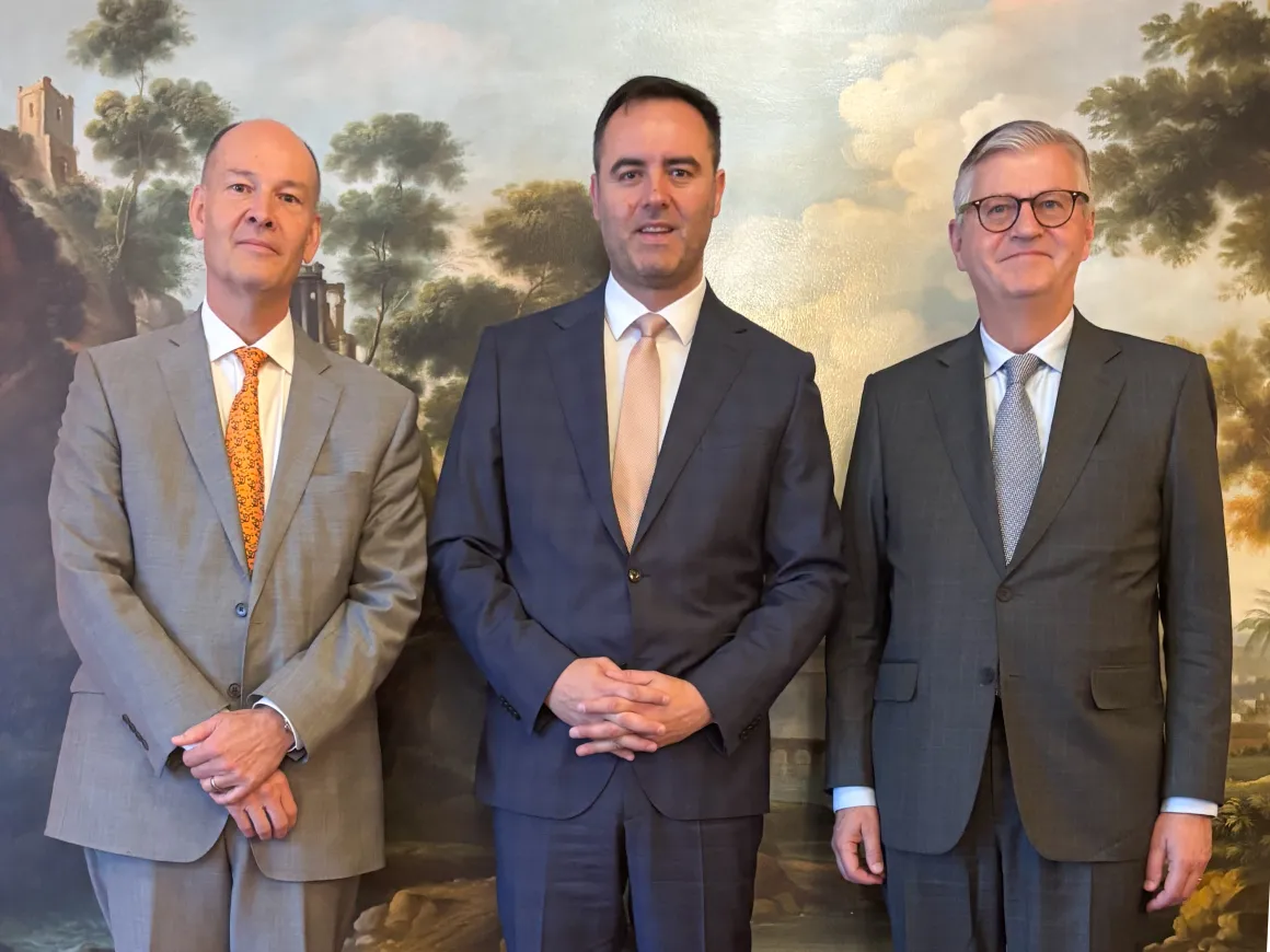 Three men in suits standing
